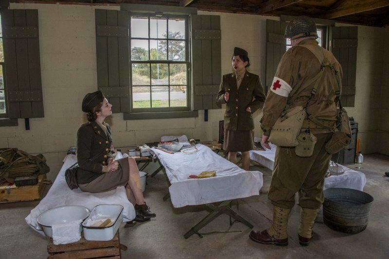 Hannah Motter, left, representing the Army Nurse Corps shares her personal collection for Fort Miles Defense Day.